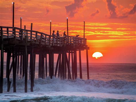 Sunrise over fishing pier at North Carolina Outer Banks #4 Photograph by Alex Smolyanyy - Pixels