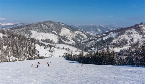 Skiers on the Mountain Slope on a Background of Mountains Stock Photo ...