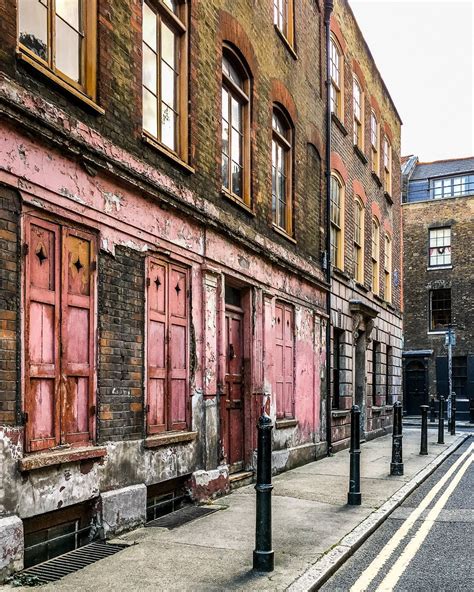 A historic house with a red facade in Spitalfields, London. A lot of films and TV shows use this ...