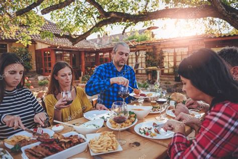 Family dining outdoor — Stock Photo © Kerkezz #175203856