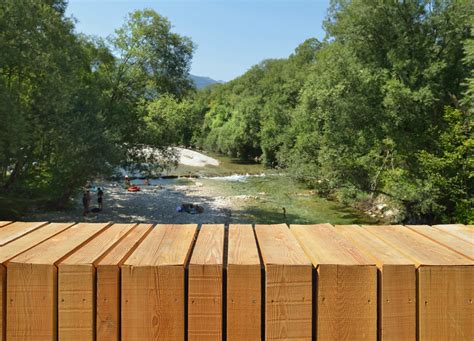 Architects create beautiful arched footbridge out of timber planks and shingles DANS Architects ...