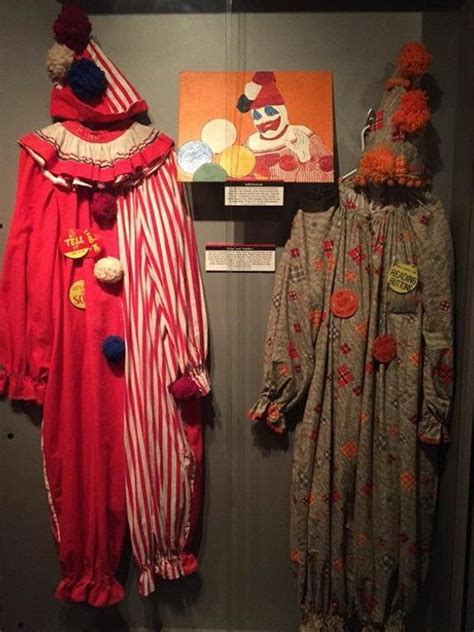 two clown costumes on display in a glass case