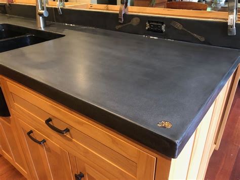 black concrete countertop with fork and spoon embedded, and shell. | Black laminate countertops ...