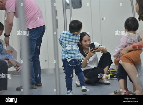 Passengers take a subway train on the Zhengzhou Metro Line 5 enabled ...