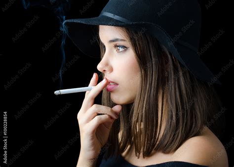 Portrait of the beautiful elegant girl smoking cigarette Stock Photo | Adobe Stock