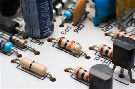 Premium Photo | Resistor, capacitor and transistor on circuit board close up. electronic hardware