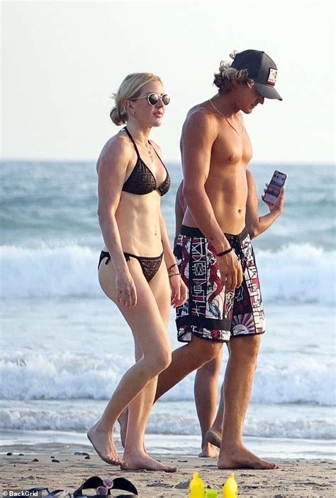 Ellie Goulding's romance with hunky surfing instructor heats up! Singer looks cosy with Armando ...