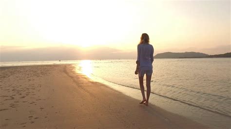 Girl Walking On Beach At Sunset Stock Footage SBV-321335453 - Storyblocks