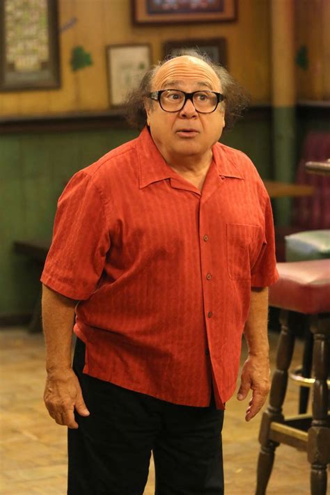 an older man with glasses standing in front of a bar stool and looking ...