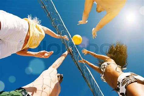 Friends playing beach volleyball | Stock image | Colourbox