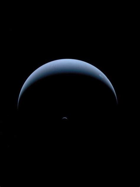 Neptune and Triton, captured by Voyager 2 on its way out of the solar ...