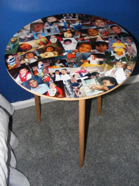 a round table with pictures on it in front of a blue wall and grey carpet