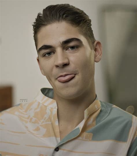 a young man making a funny face while wearing a shirt with an orange ...