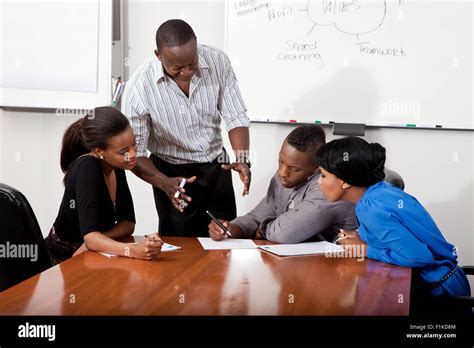 Overall shot of a boardroom meeting involving black business people ...