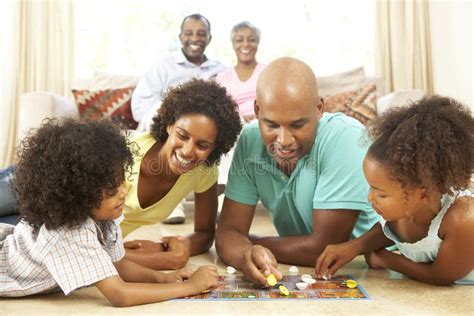 Family Playing Board Game At Home Stock Photo - Image of nine, group: 11502350