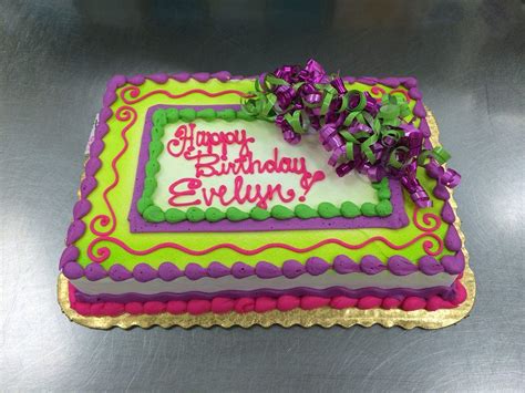 a birthday cake with purple and green decorations