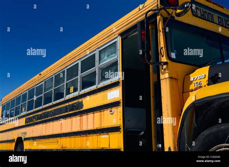 Old rusting abandoned school bus in a junkyard with blue sky in winter Stock Photo - Alamy