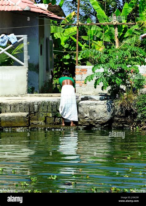 Lady carrying out the weekly laundry Stock Photo - Alamy