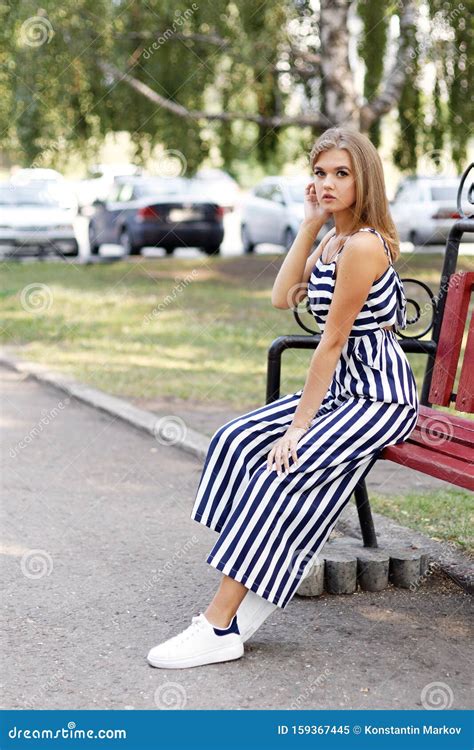 Young Attractive Girl Sitting Alone on a Bench Stock Image - Image of ...