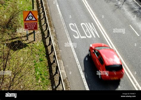 Speeding car approaching warning to slow down, on UK road Stock Photo - Alamy