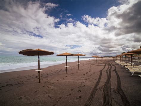 beach with umbrellas in Giardini Naxos - Eternal Arrival