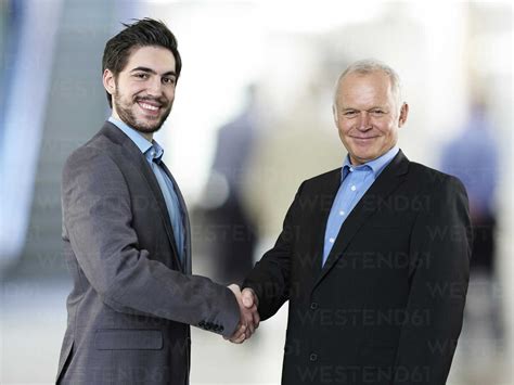 Portrait of two business men shaking hands stock photo