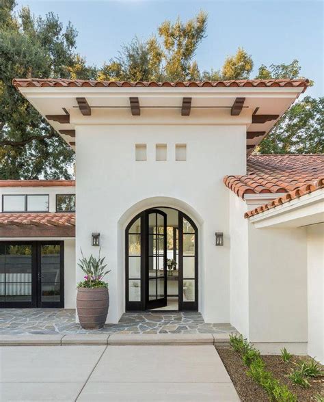 Modern Spanish style home with black arched glass door | Marianne Simon ...