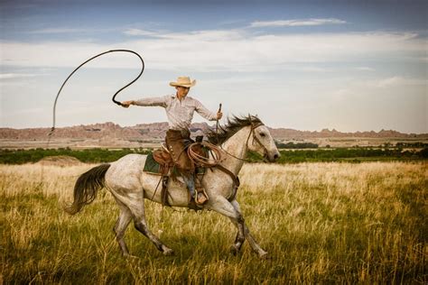 by Rikk Flohr. "Cowboy, Paul Kruse shows off some whip tricks..." during a photographic workshop ...