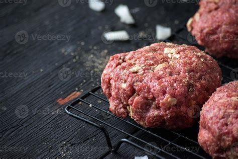 raw hamburger patties with onions and herbs 10054339 Stock Photo at ...