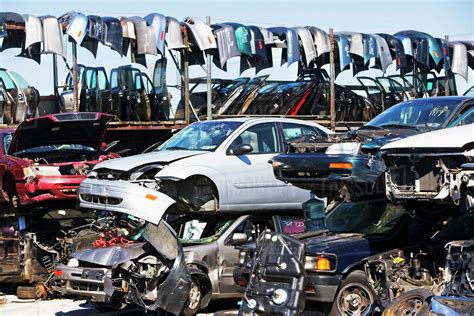 Cars and car parts in junkyard - Stock Photo - Dissolve