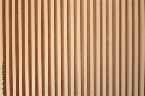 Light brown slats of wood. Lines of wooden slats form a striped texture ...