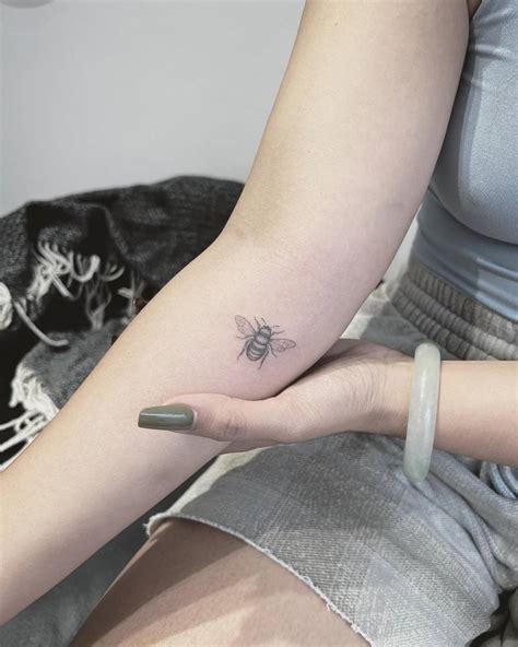 Little bee tattoo located on the inner forearm.