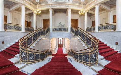 an ornate building with red carpet and stairs