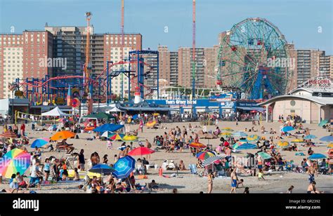 Coney Island beach with the boardwalk and Luna Park rides in the background. New York Stock ...