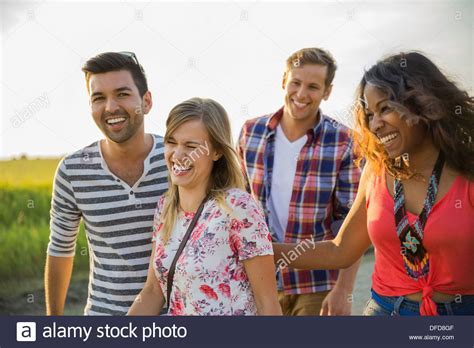 Group of friends laughing outdoors Stock Photo - Alamy