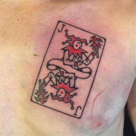 Hand poked joker playing card tattoo on the chest.