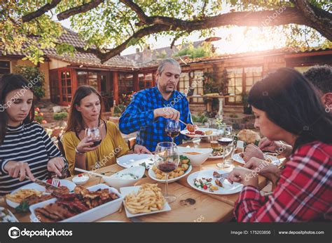 Family dining outdoor — Stock Photo © Kerkezz #175203856