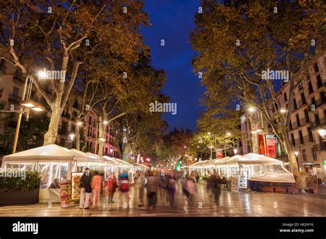 La Rambla (Las Ramblas) tree-lined boulevard witch cafes at night in Barcelona, city landmark ...