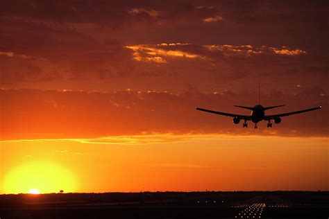 Plane Landing At Sunset