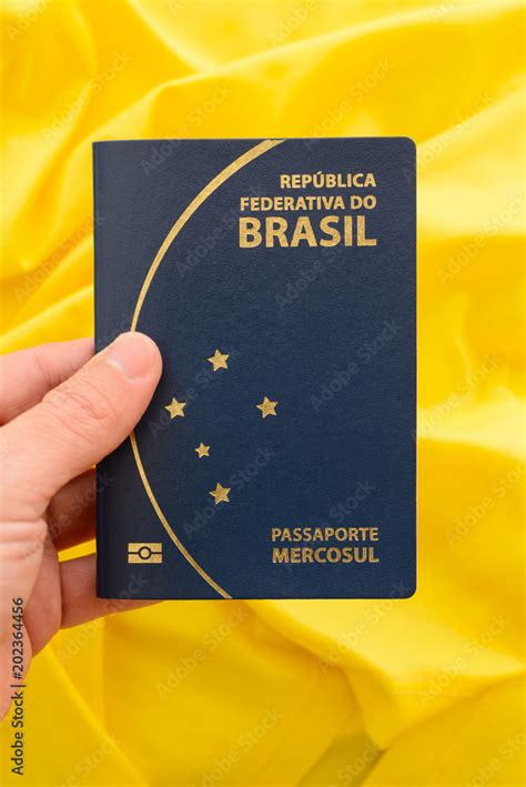 Brazilian passport on yellow fabric representing the Brazilian flag ...