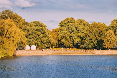 Premium Photo | People resting in Munster city park and watching sunset over Aasee lake