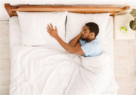 Young black guy sleeping innocently in his bed – International Institute of Sleep