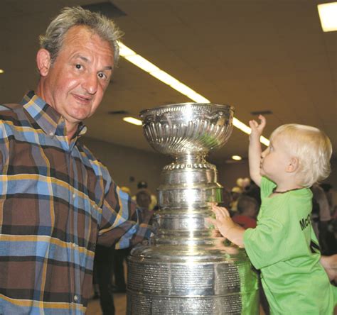 Darryl Sutter all smiles showing Stanley Cup to friends and family in ...