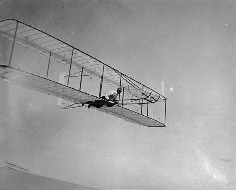 Wilbur Wright practicing in glider #3, 1 year before first successful powered flight, Kitty Hawk ...