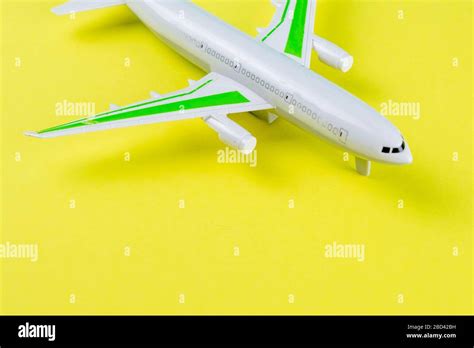 Miniature toy airplane on yellow background. Trip by airplane Stock Photo - Alamy