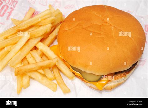 Mcdonalds cheeseburger and french fries on open wrapper Stock Photo - Alamy