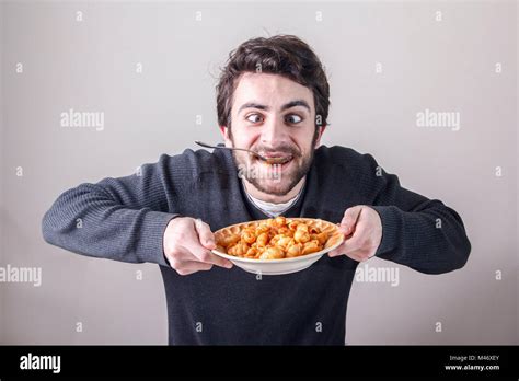 Hungry man eating food Stock Photo - Alamy