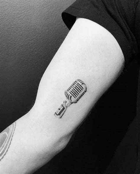 Single needle microphone tattoo on the right inner arm.