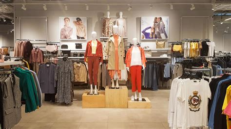 Three dressed mannequins standing in a store. Casual women's clothing ...