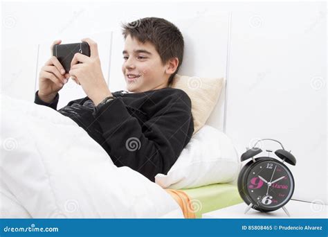 Child mobile phone on bed stock image. Image of latin - 85808465